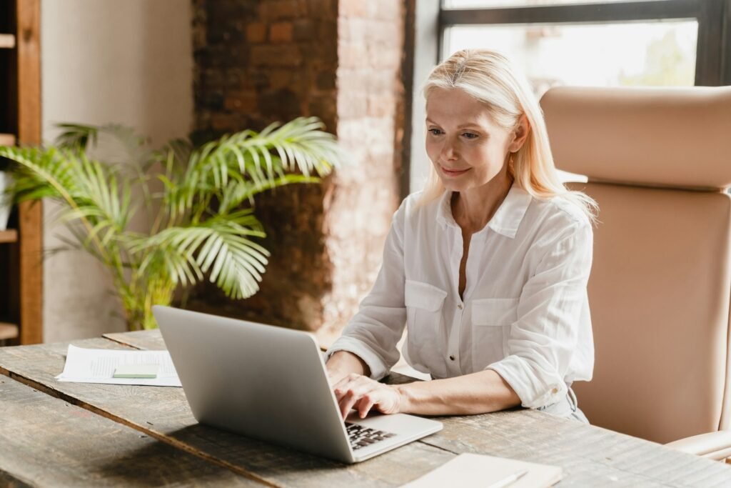 Tutor teacher working typing on laptop, searching information, social media surfing online in office